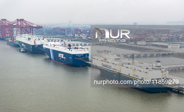 Cars are loaded and unloaded at a ro-ro vehicle terminal for export at Taicang Port area in Suzhou, East China's Jiangsu province, on Decemb...