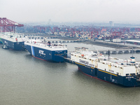 Cars are loaded and unloaded at a ro-ro vehicle terminal for export at Taicang Port area in Suzhou, East China's Jiangsu province, on Decemb...