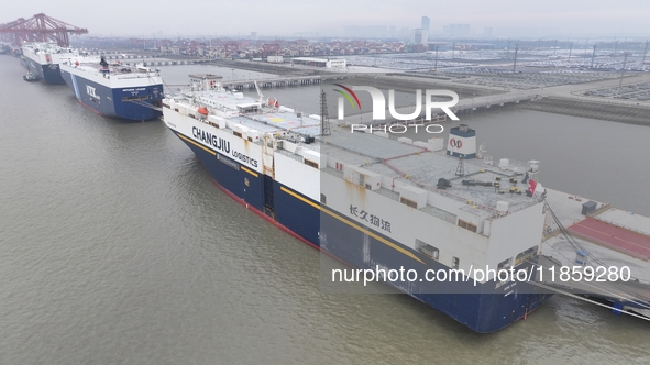 Cars are loaded and unloaded at a ro-ro vehicle terminal for export at Taicang Port area in Suzhou, East China's Jiangsu province, on Decemb...