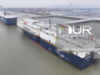 Cars are loaded and unloaded at a ro-ro vehicle terminal for export at Taicang Port area in Suzhou, East China's Jiangsu province, on Decemb...