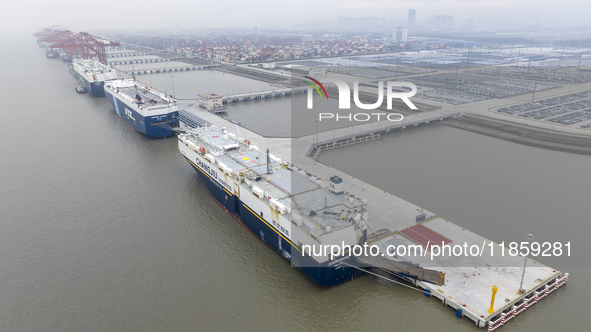 Cars are loaded and unloaded at a ro-ro vehicle terminal for export at Taicang Port area in Suzhou, East China's Jiangsu province, on Decemb...