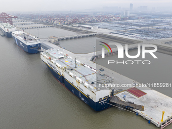 Cars are loaded and unloaded at a ro-ro vehicle terminal for export at Taicang Port area in Suzhou, East China's Jiangsu province, on Decemb...