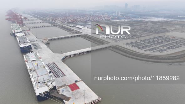 Cars are loaded and unloaded at a ro-ro vehicle terminal for export at Taicang Port area in Suzhou, East China's Jiangsu province, on Decemb...