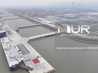 Cars are loaded and unloaded at a ro-ro vehicle terminal for export at Taicang Port area in Suzhou, East China's Jiangsu province, on Decemb...