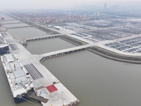 Cars are loaded and unloaded at a ro-ro vehicle terminal for export at Taicang Port area in Suzhou, East China's Jiangsu province, on Decemb...