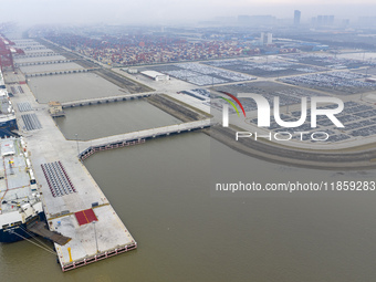 Cars are loaded and unloaded at a ro-ro vehicle terminal for export at Taicang Port area in Suzhou, East China's Jiangsu province, on Decemb...