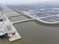 Cars are loaded and unloaded at a ro-ro vehicle terminal for export at Taicang Port area in Suzhou, East China's Jiangsu province, on Decemb...