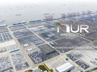 Cars are loaded and unloaded at a ro-ro vehicle terminal for export at Taicang Port area in Suzhou, East China's Jiangsu province, on Decemb...