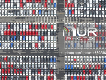 Cars are loaded and unloaded at a ro-ro vehicle terminal for export at Taicang Port area in Suzhou, East China's Jiangsu province, on Decemb...