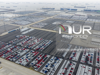 Cars are loaded and unloaded at a ro-ro vehicle terminal for export at Taicang Port area in Suzhou, East China's Jiangsu province, on Decemb...