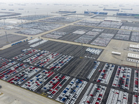 Cars are loaded and unloaded at a ro-ro vehicle terminal for export at Taicang Port area in Suzhou, East China's Jiangsu province, on Decemb...