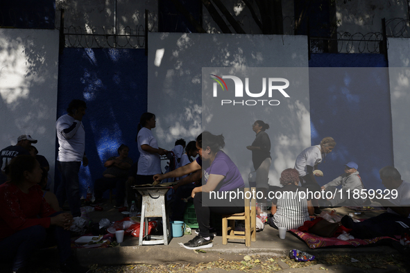 Pilgrims from different states of the Mexican Republic eat on the street during their journey to the Basilica of Guadalupe located in Mexico...