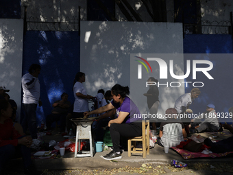 Pilgrims from different states of the Mexican Republic eat on the street during their journey to the Basilica of Guadalupe located in Mexico...