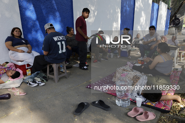 Pilgrims from different states of the Mexican Republic eat on the street during their journey to the Basilica of Guadalupe located in Mexico...