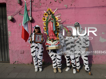 Pilgrims from different states of the Mexican Republic pose during their journey to the Basilica of Guadalupe in Mexico City, Mexico, on Dec...