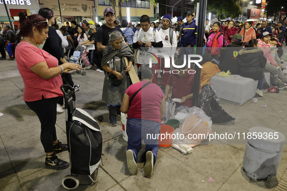 Pilgrims from different states of the Mexican Republic eat on the street during their journey to the Basilica of Guadalupe located in Mexico...