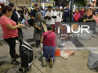 Pilgrims from different states of the Mexican Republic eat on the street during their journey to the Basilica of Guadalupe located in Mexico...