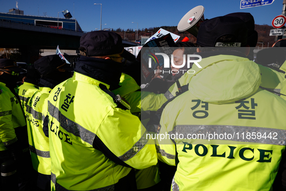 Protesters hold portraits of President Yoon Suk-yeol with the phrase ''Arrest Yoon Suk-yeol, the Rebellion Leader'' written on them as they...