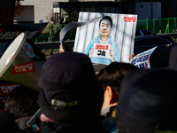 Protesters hold portraits of President Yoon Suk-yeol with the phrase ''Arrest Yoon Suk-yeol, the Rebellion Leader'' written on them as they...