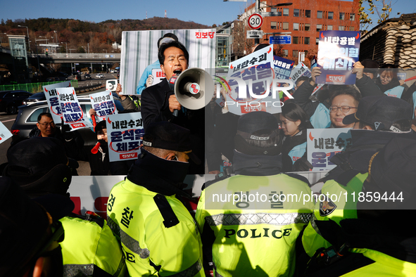 Protesters hold portraits of President Yoon Suk-yeol with the phrase ''Arrest Yoon Suk-yeol, the Rebellion Leader'' written on them as they...