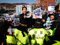 Protesters hold portraits of President Yoon Suk-yeol with the phrase ''Arrest Yoon Suk-yeol, the Rebellion Leader'' written on them as they...