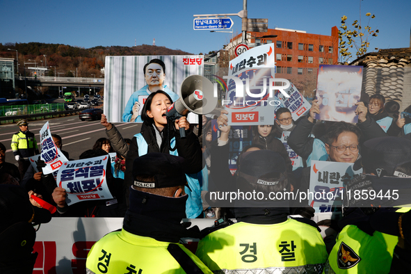 Protesters hold portraits of President Yoon Suk-yeol with the phrase ''Arrest Yoon Suk-yeol, the Rebellion Leader'' written on them as they...