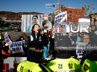 Protesters hold portraits of President Yoon Suk-yeol with the phrase ''Arrest Yoon Suk-yeol, the Rebellion Leader'' written on them as they...