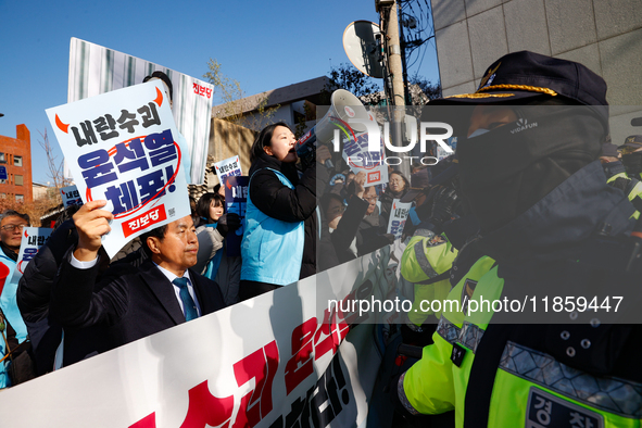 Protesters hold portraits of President Yoon Suk-yeol with the phrase ''Arrest Yoon Suk-yeol, the Rebellion Leader'' written on them as they...