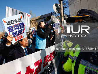 Protesters hold portraits of President Yoon Suk-yeol with the phrase ''Arrest Yoon Suk-yeol, the Rebellion Leader'' written on them as they...