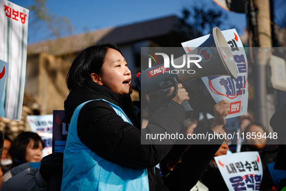 Protesters hold portraits of President Yoon Suk-yeol with the phrase ''Arrest Yoon Suk-yeol, the Rebellion Leader'' written on them as they...