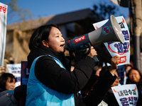 Protesters hold portraits of President Yoon Suk-yeol with the phrase ''Arrest Yoon Suk-yeol, the Rebellion Leader'' written on them as they...