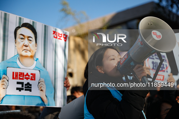 Protesters hold portraits of President Yoon Suk-yeol with the phrase ''Arrest Yoon Suk-yeol, the Rebellion Leader'' written on them as they...