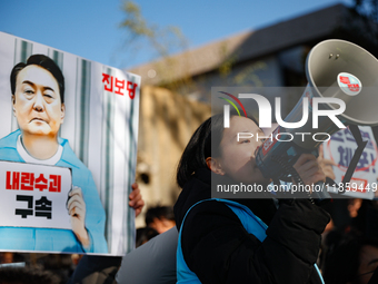 Protesters hold portraits of President Yoon Suk-yeol with the phrase ''Arrest Yoon Suk-yeol, the Rebellion Leader'' written on them as they...