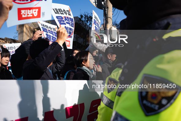 Protesters hold portraits of President Yoon Suk-yeol with the phrase ''Arrest Yoon Suk-yeol, the Rebellion Leader'' written on them as they...