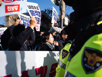 Protesters hold portraits of President Yoon Suk-yeol with the phrase ''Arrest Yoon Suk-yeol, the Rebellion Leader'' written on them as they...