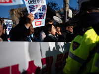 Protesters hold portraits of President Yoon Suk-yeol with the phrase ''Arrest Yoon Suk-yeol, the Rebellion Leader'' written on them as they...