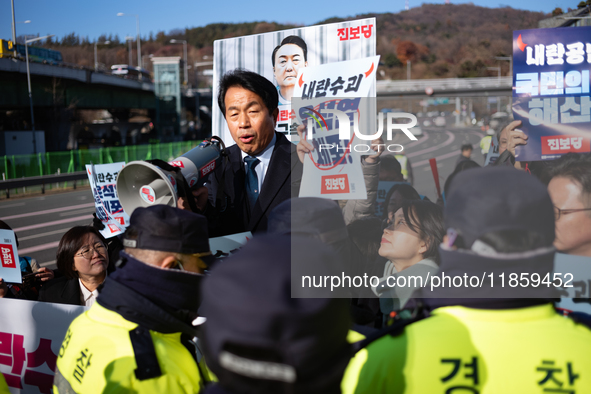 Protesters hold portraits of President Yoon Suk-yeol with the phrase ''Arrest Yoon Suk-yeol, the Rebellion Leader'' written on them as they...