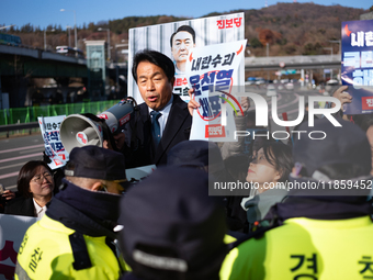 Protesters hold portraits of President Yoon Suk-yeol with the phrase ''Arrest Yoon Suk-yeol, the Rebellion Leader'' written on them as they...