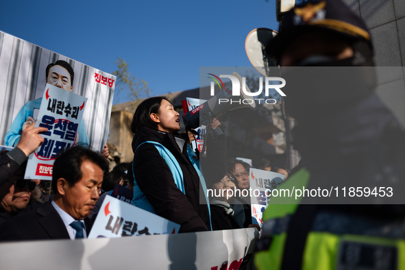 Protesters hold portraits of President Yoon Suk-yeol with the phrase ''Arrest Yoon Suk-yeol, the Rebellion Leader'' written on them as they...