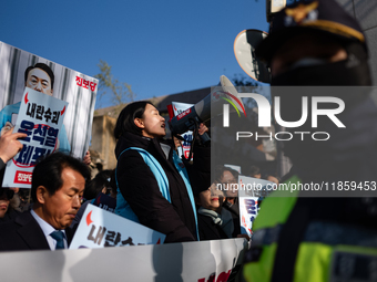 Protesters hold portraits of President Yoon Suk-yeol with the phrase ''Arrest Yoon Suk-yeol, the Rebellion Leader'' written on them as they...