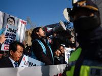 Protesters hold portraits of President Yoon Suk-yeol with the phrase ''Arrest Yoon Suk-yeol, the Rebellion Leader'' written on them as they...