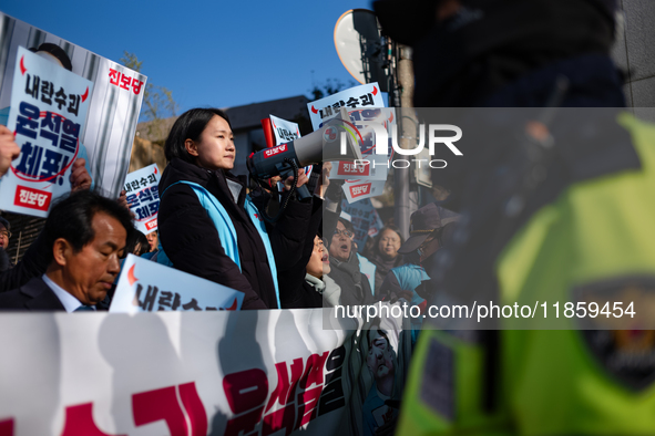 Protesters hold portraits of President Yoon Suk-yeol with the phrase ''Arrest Yoon Suk-yeol, the Rebellion Leader'' written on them as they...