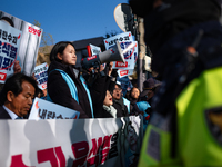 Protesters hold portraits of President Yoon Suk-yeol with the phrase ''Arrest Yoon Suk-yeol, the Rebellion Leader'' written on them as they...