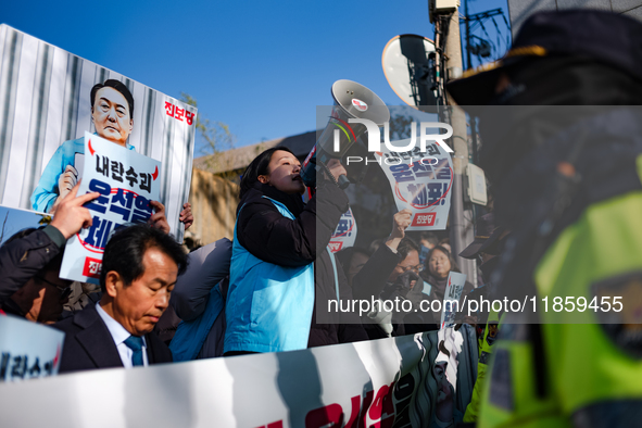 Protesters hold portraits of President Yoon Suk-yeol with the phrase ''Arrest Yoon Suk-yeol, the Rebellion Leader'' written on them as they...