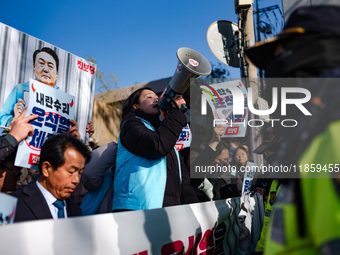 Protesters hold portraits of President Yoon Suk-yeol with the phrase ''Arrest Yoon Suk-yeol, the Rebellion Leader'' written on them as they...