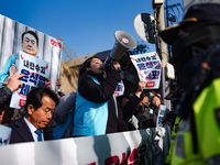 Protesters hold portraits of President Yoon Suk-yeol with the phrase ''Arrest Yoon Suk-yeol, the Rebellion Leader'' written on them as they...