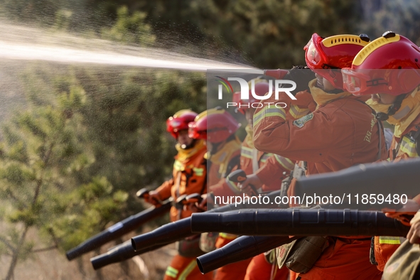 A comprehensive combat drill for forest fire emergency response takes place in Qingdao, China, on December 11, 2024. 