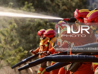 A comprehensive combat drill for forest fire emergency response takes place in Qingdao, China, on December 11, 2024. (