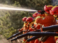 A comprehensive combat drill for forest fire emergency response takes place in Qingdao, China, on December 11, 2024. (