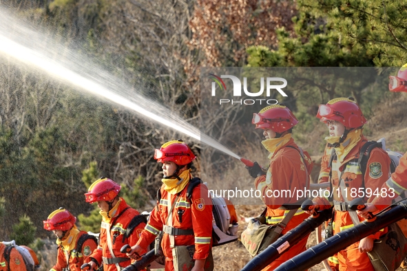 A comprehensive combat drill for forest fire emergency response takes place in Qingdao, China, on December 11, 2024. 